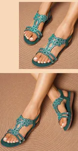 Detailed top and side view of Bohemian flat sandals featuring green rhinestone flowers