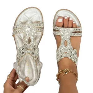 Bohemian silver flat sandals with sparkling rhinestone flower decor, comfortable sole.
