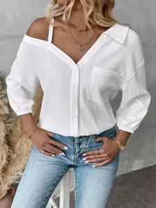 Macro detail view of a white textured off-shoulder shirt with single-breasted buttons