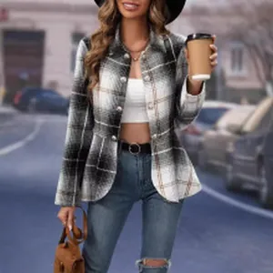 Detailed view of a fashionable women's black and white plaid blazer jacket in street setting