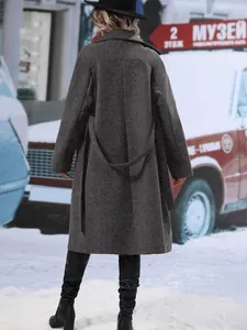 Back view of an elegant grey notch lapel wool blend coat with a matching tie-waist belt.