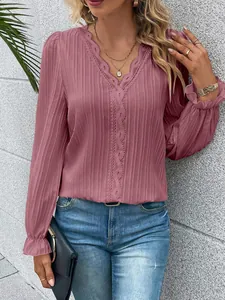 Close-up of rose pink long sleeve blouse with lace hollow detail and pleated fabric