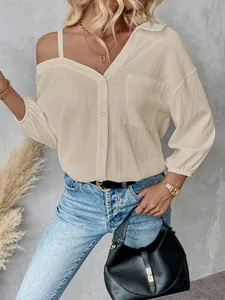 Detailed view of cream off-the-shoulder textured blouse with button-up front design