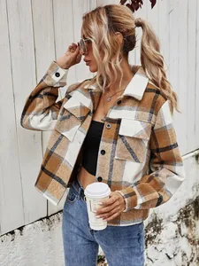 Detailed view of women's cropped plaid jacket with lapel and button closure.
