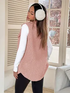 Detail of the soft texture and back fit of a pink faux shearling vest on a model