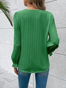 Back view of a green long-sleeved shirt with elegant vertical texture and ruffled cuffs