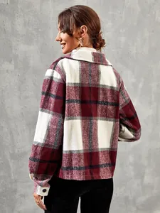 Back view of a red and white plaid shirt jacket worn by a model against a gray wall