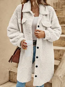 Detailed view of long white fuzzy teddy coat with lapel collar and button closure