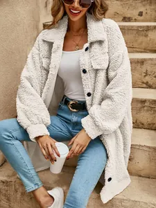 Detail of white oversized plush teddy coat with lapels and buttons