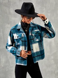 Detail of a blue and white plaid flannel jacket featuring lapels and front pockets