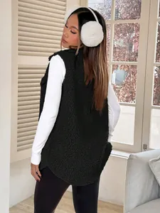 Back view of black fuzzy faux lamb wool vest on a female model in a winter setting