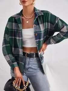 Close-up detail of a green plaid woolen shacket with button-down design and lapel collar