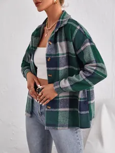 Close-up of green plaid woolen shacket featuring lapel and single-breasted buttons