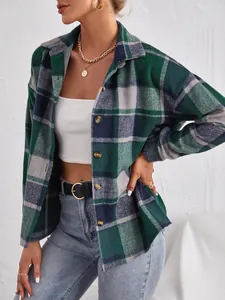 Detail of a green plaid button-down shacket with lapel collar for women.