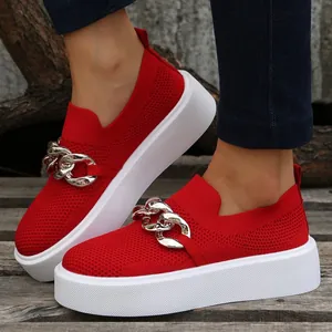 Side view detail of red mesh slip-on shoes with silver chain and thick white platform