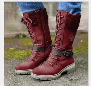 Detailed view of burgundy mid-calf lace-up boots with knitted collar and lug sole