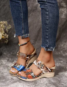 Detailed view of vintage snake print platform wedge sandals featuring 3D floral accents