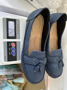 Women's blue suede-style tassel loafers shown on a digital scale with a weight of 342g