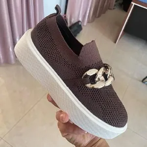 Detailed view of women's brown breathable knit slip-on sneaker featuring a silver chain