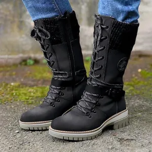 Stylish black mid-calf boots with knitted paneling and a rugged lug sole detail.