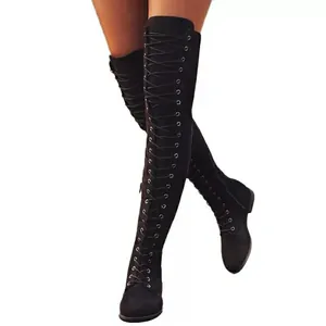 Macro view of black lace-up over-the-knee boots with flat heel for stylish women