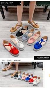 Detailed view showing multi-color tassel platform sandals with Mary Jane buckle straps