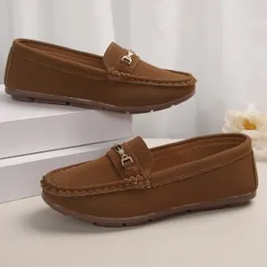 Brown suede flat loafers for women with gold metal buckle detail on white background