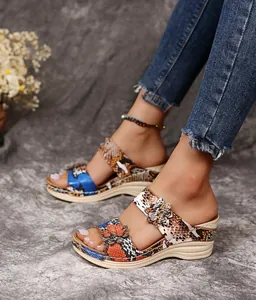 Detailed view of retro beach wedge sandals with floral patterns and snakeskin texture