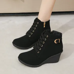 Seitenansicht schwarze Keilstiefeletten für Damen mit goldener Schnalle und Schnürung