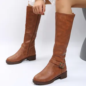 Side view of brown knee-high knight boots with buckle detail and low heel