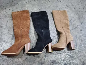 Trio of suede high-heel knee-high boots in brown, black, and khaki colors