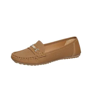 Detail view of brown women's loafers showing the perforated texture and golden horsebit buckle.