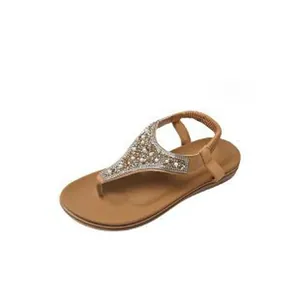 Detailed view of Bohemian flat sandals featuring elegant pearl and rhinestone T-strap decoration