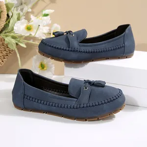 Close-up of blue suede loafers with tassels and soft soles for women