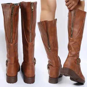 Detail of brown knee-high boots featuring a full-length back zipper and low heel.