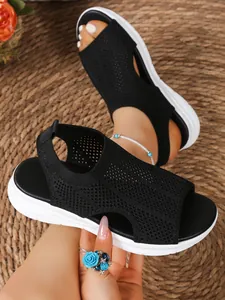 Close-up detail showing the breathable black fly-knit mesh and white sole of platform sandals