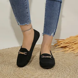 Detailed view of comfortable black women's loafers with elegant gold metal buckle
