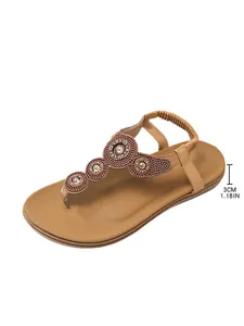 Close-up detail of bohemian T-strap flat sandal with 3cm heel height annotation