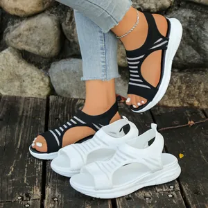 Detailed view of black and white women's knit wedge sandals with fish mouth design.