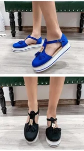 Close-up view of stylish women's tassel platform sandals with white chunky soles