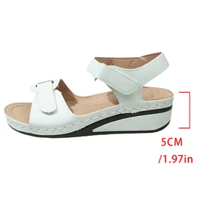 Detailed side view of white women's wedge sandals with a 5cm heel height measurement info