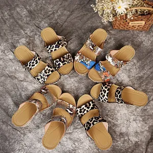 Detail view of various vintage leopard and snakeskin wedge sandals arranged in a circle.