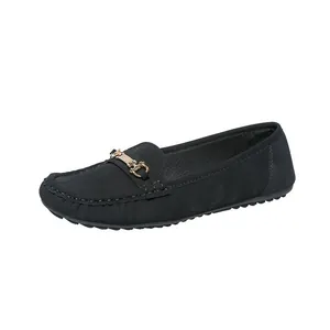 Elegant black women's loafers with a decorative golden horsebit buckle on the front