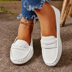 Close-up view of white leather loafers for women with a round toe and pebbled texture
