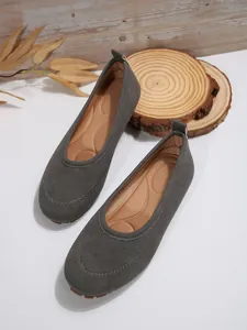 Top-down view of grey suede women's flat loafers showing soft cushioned inner sole