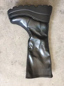 Side view of black platform knee-high boot showing thick serrated sole details