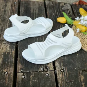 Detail of white knitted wedge sandals featuring breathable fish mouth hollow design