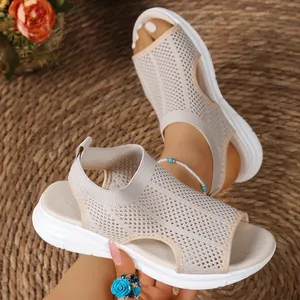 Close-up detail of beige mesh wedge sandals with breathable fish-toe design for summer
