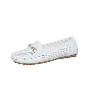 Detailed side view of white perforated women's loafers with gold horsebit