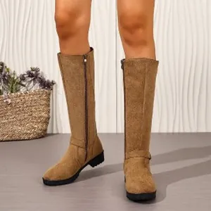 Detailed macro view of tan suede knee-high knight boots with side zipper design
